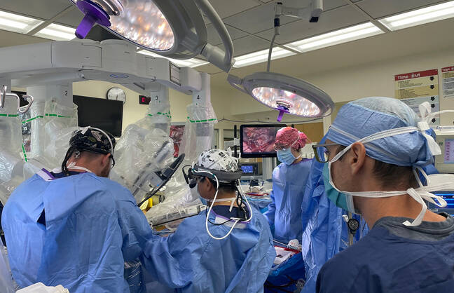 Image of doctors performing robot-assisted mitral valve repair surgery