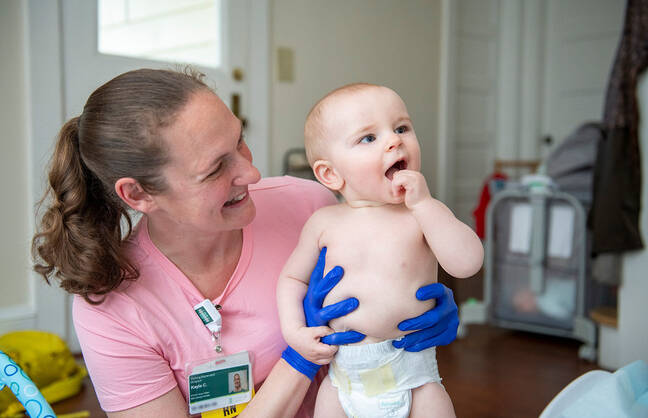 Health provider holding a baby