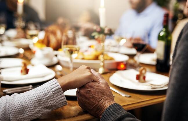 Holding hands at a holiday meal
