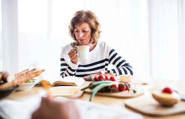 Woman thinking at a dining table