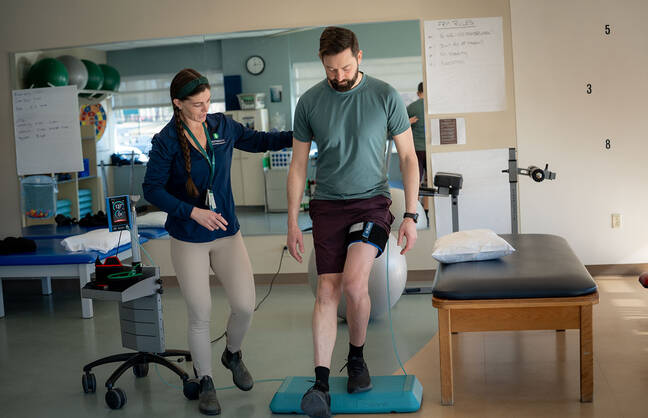 A physical therapist treating a patient