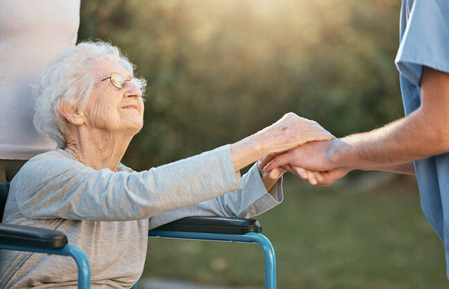 woman holding hands with another