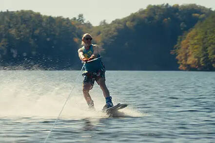 John Nolan waterskiing on a lake