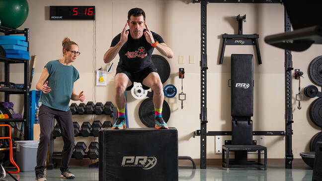 Male patient doing physical rehabilitation exercises while provider supervises