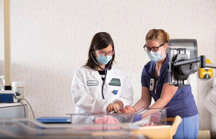 TeleICN specialists working with a newborn